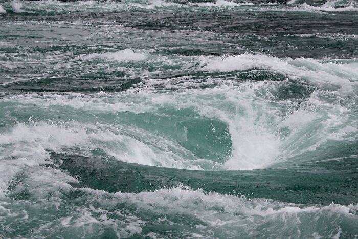 Swirling ocean whirlpool showcasing stunning natural phenomena.