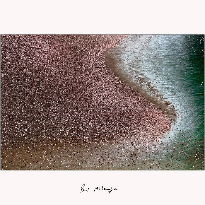 Aerial view of swirling pink and green patterns captured by Paul McKenzie at an African soda lake.