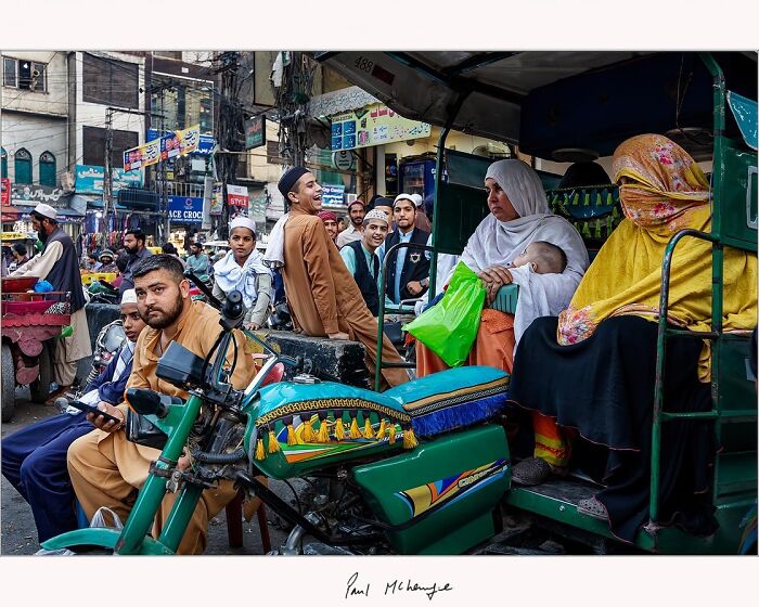 Street scene with vibrant market activity captured by Paul McKenzie, showcasing cultural diversity.