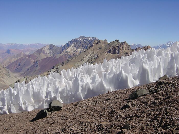 Snow formations called penitentes on Andes mountains, illustrating stunning and strange natural phenomena.