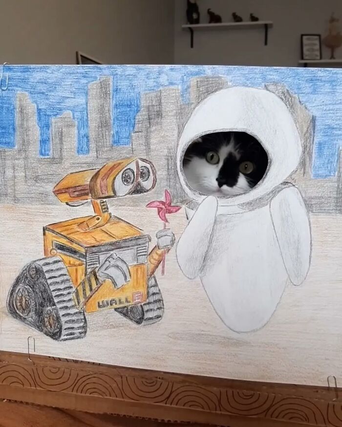 Cat made into living art, peering through a drawing of WALL-E and EVE with a cityscape background.