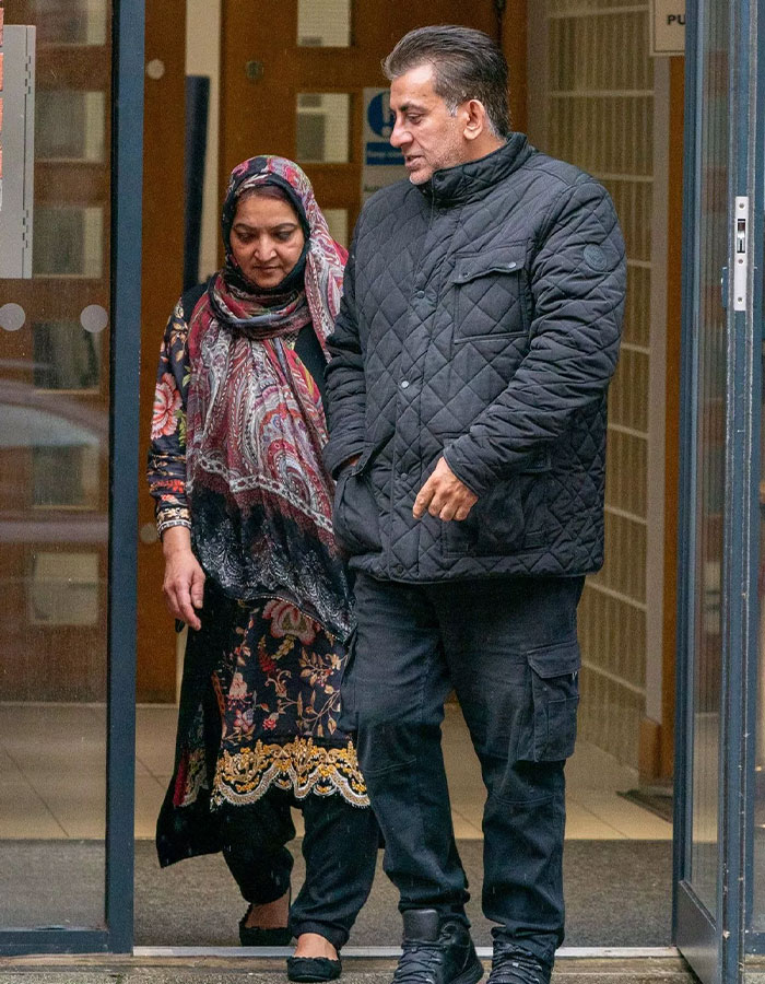 Two people exiting a building, wearing winter clothing, associated with arranged marriage case.