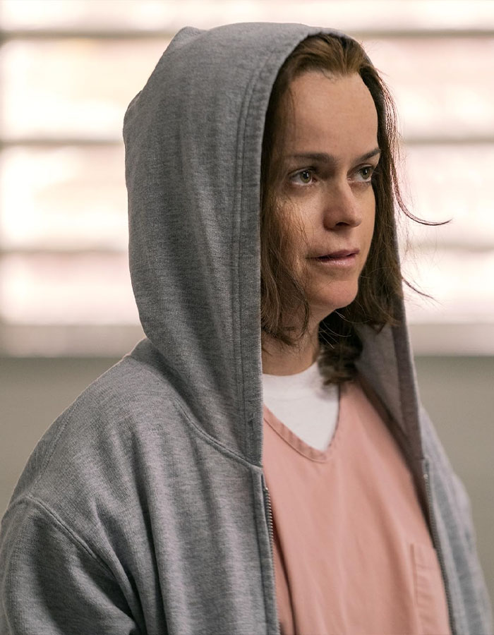 Orange Is The New Black actress in a gray hoodie and pink shirt, sparking worry with new look.