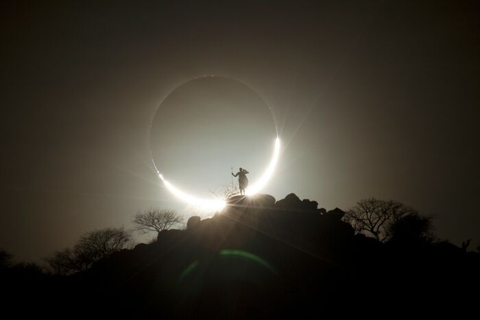 Photographer Of The Year - Event: Hybrid Solar Eclipse And Maasai Warrior By Eugen Kamenew