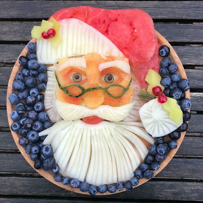 Fruits and vegetables arranged into an artistic Santa face, showcasing creative healthy eating art.