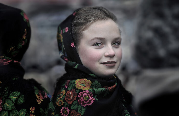 A girl in a floral headscarf, representing the beauty of everyday people in Istvan Kerekes' photography.