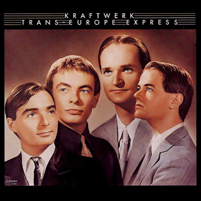 '70s band Kraftwerk's "Trans Europe Express" album cover, featuring four members in suits, iconic retro style.