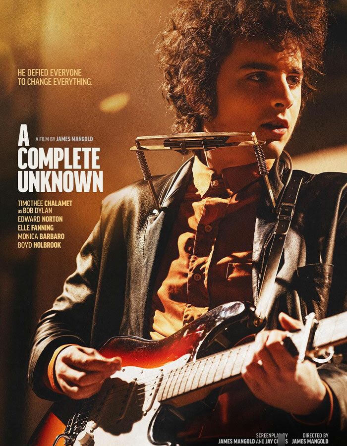 Timothée Chalamet as Bob Dylan in "A Complete Unknown," holding a guitar.