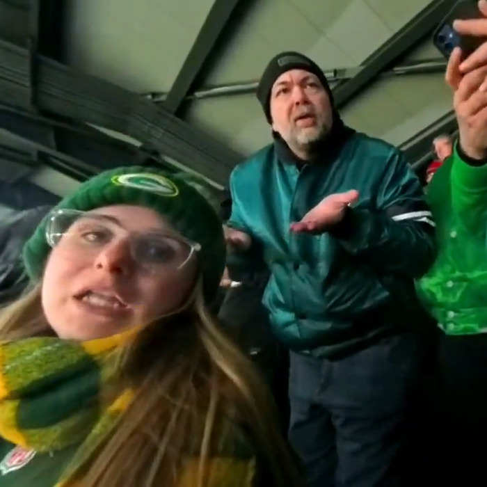 Fans at a game, with one person looking upset; online sleuths focus on this Eagles fan.