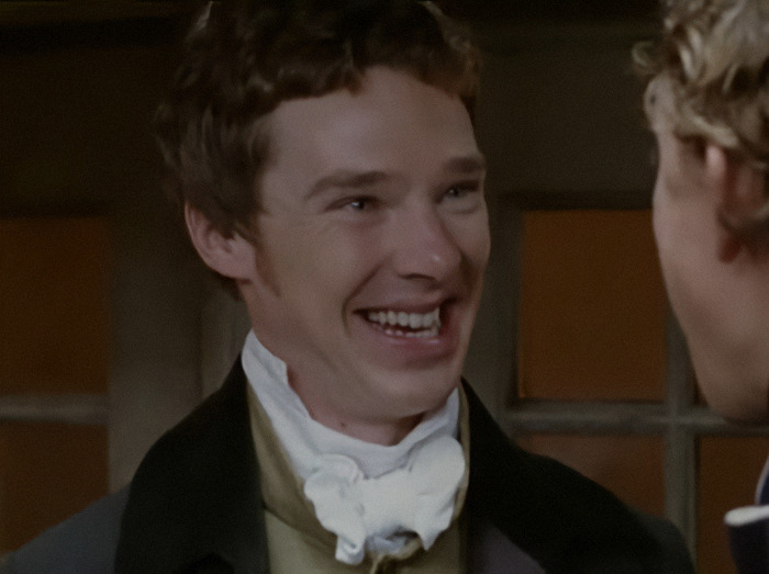 A historical drama scene featuring Benedict Cumberbatch in period costume, smiling brightly on a scene from 'To the Ends of the Earth.