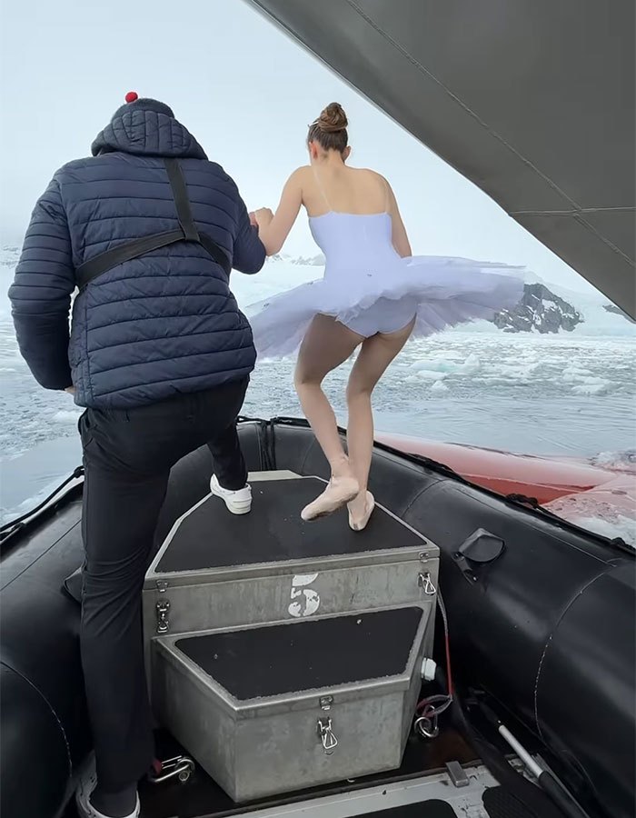 Ballerina dancing on a ship's bow in Antarctica, illustrating career ending danger in icy waters.