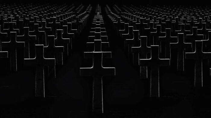 Rows of dark crosses in a cemetery, part of the winning photos from The Artist Gallery Awards 2024.