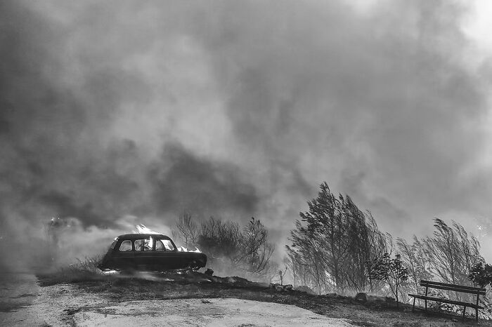 Black and white photo from The Artist Gallery Awards depicting an abandoned car in a smoky landscape.