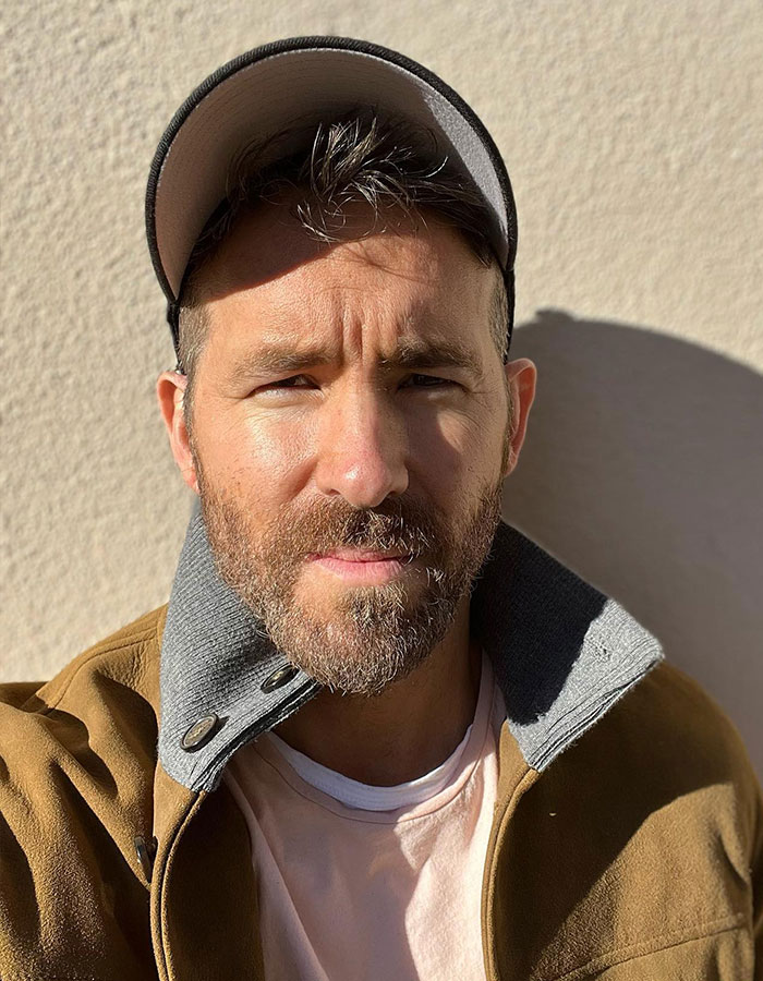 Man in casual clothing wearing a baseball cap in the sunlight, associated with lawsuit involving Justin Baldoni.