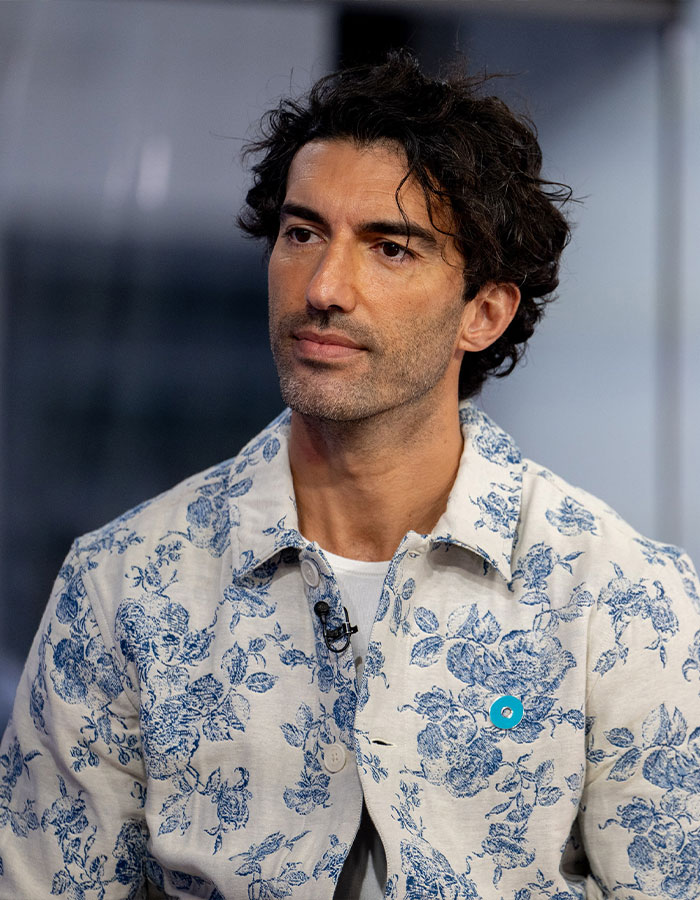 Man in a floral patterned shirt looking thoughtful; related to high-profile lawsuit.