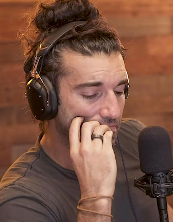 Person with headphones speaking into a microphone, related to lawsuit involving Justin Baldoni.