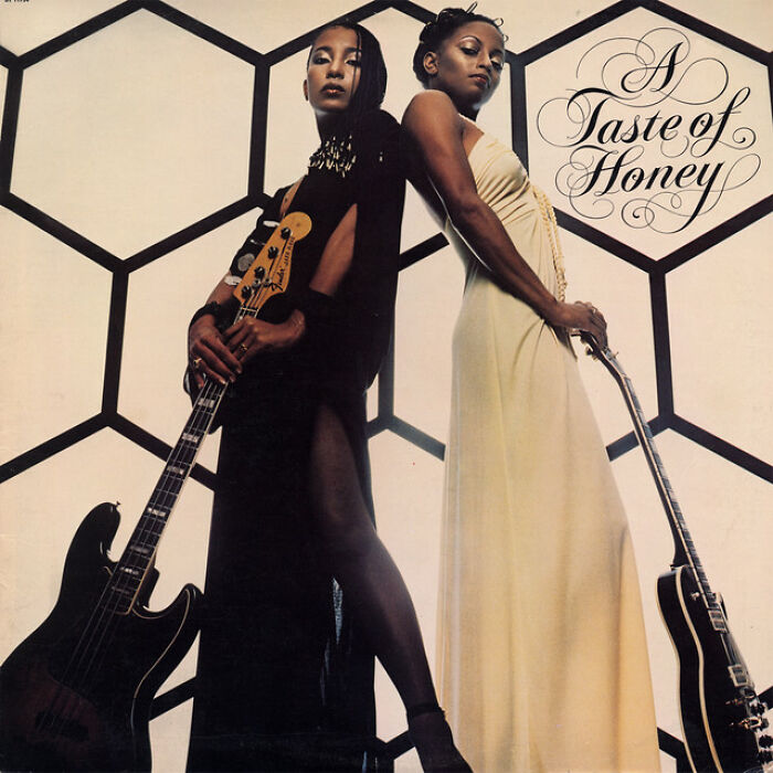 'A Taste of Honey' album cover featuring two women with guitars, highlighting iconic '70s songs.