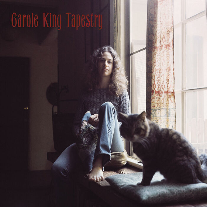 '70s singer sitting by a window with a cat, album cover for Tapestry.