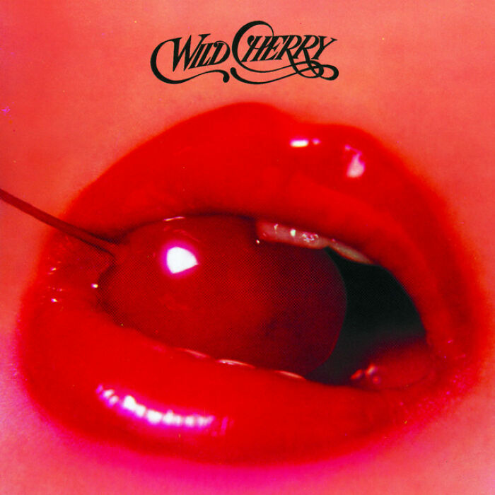 Wild Cherry album cover with glossy red lips holding a cherry, symbolizing iconic '70s music.