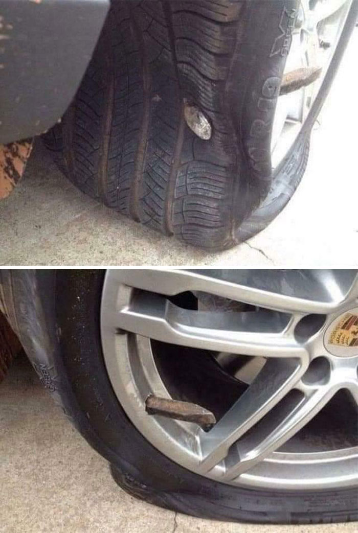 A large rock embedded in a car tire, showcasing an absolute unit lodged in the wheel.