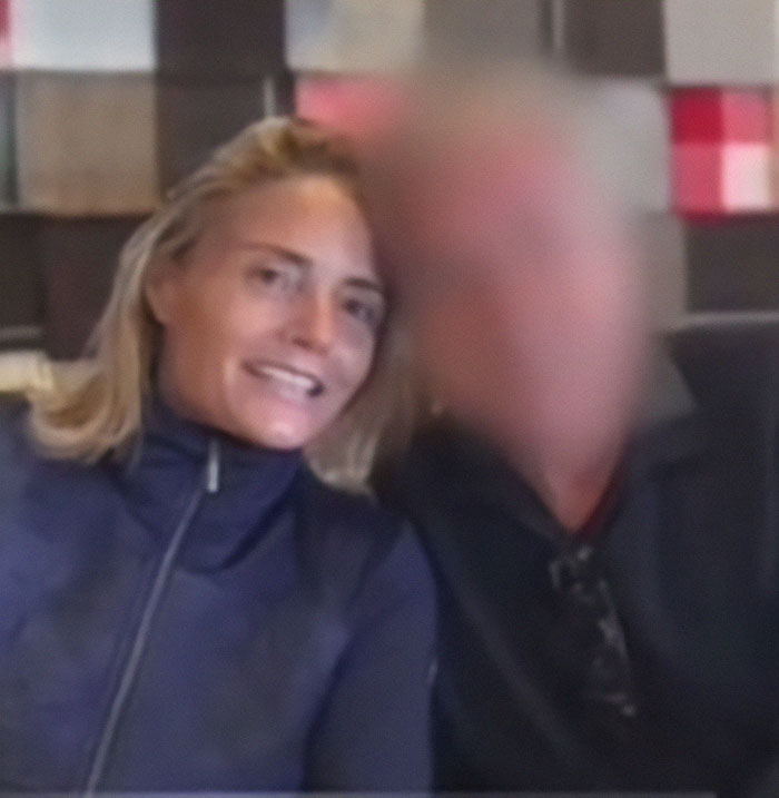 A woman smiles next to a blurred individual related to a fake AI scam involving 800k euros.