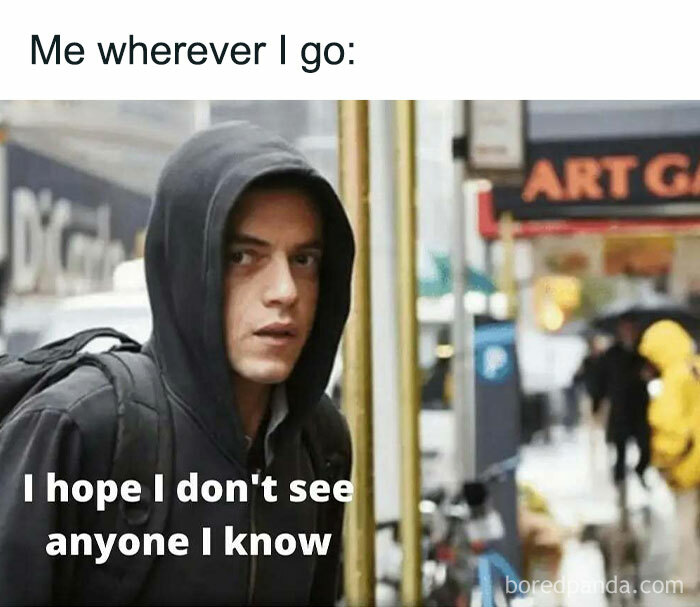 Introvert meme showing a person in a hoodie, hoping not to see anyone familiar on a city street.