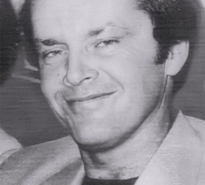 Black and white photo of a celebrity smiling, highlighting celebrity secrets and scandals theme.