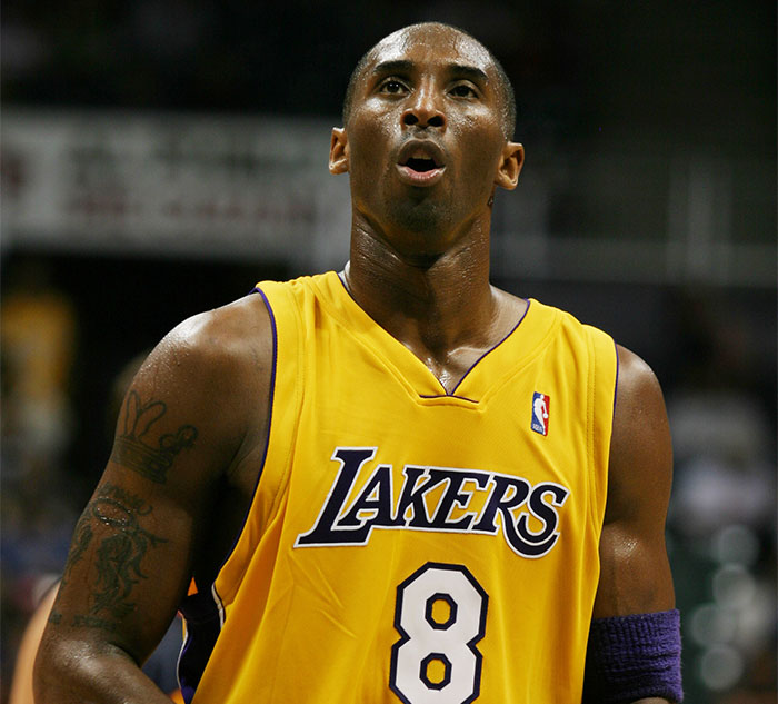 Basketball player in a Lakers jersey on the court, representing celebrity secrets and scandals theme.