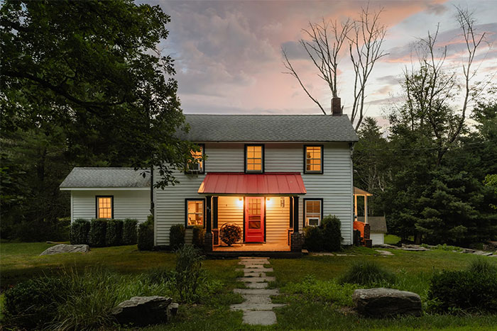 Charming house exterior at dusk, exemplifying collective waste of resources on unneeded renovations.