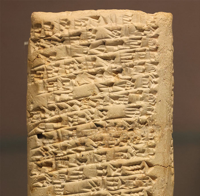 Ancient cuneiform tablet symbolizing historical collective madness in financial waste.