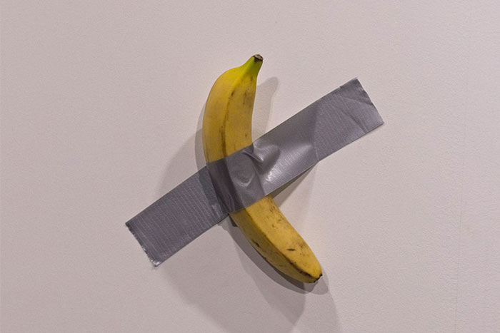 A banana duct-taped to a wall, symbolizing wasted money in modern art.