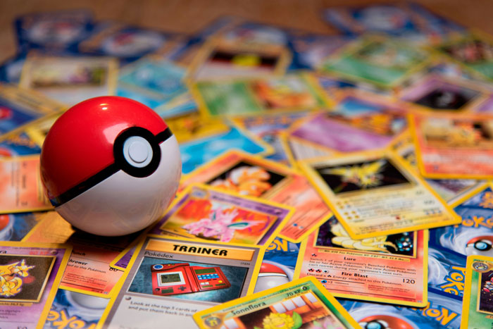 Pokémon cards scattered with a Poké Ball for a boyfriend\'s Christmas gift.