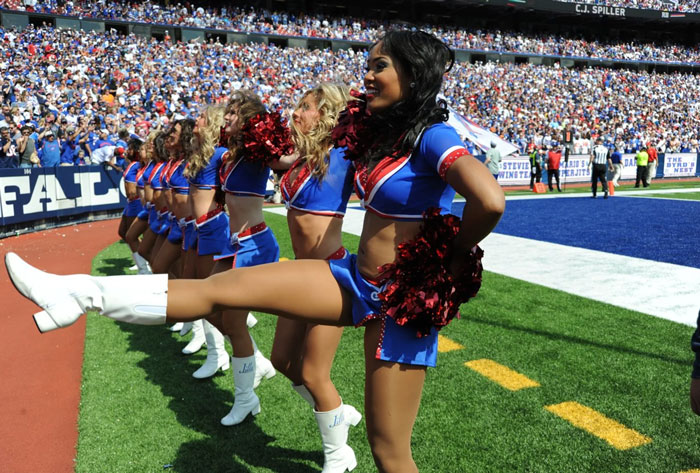 Cheerleaders in blue and red uniforms performing on the sidelines of a football game, following strict Buffalo Bills cheerleader rules.