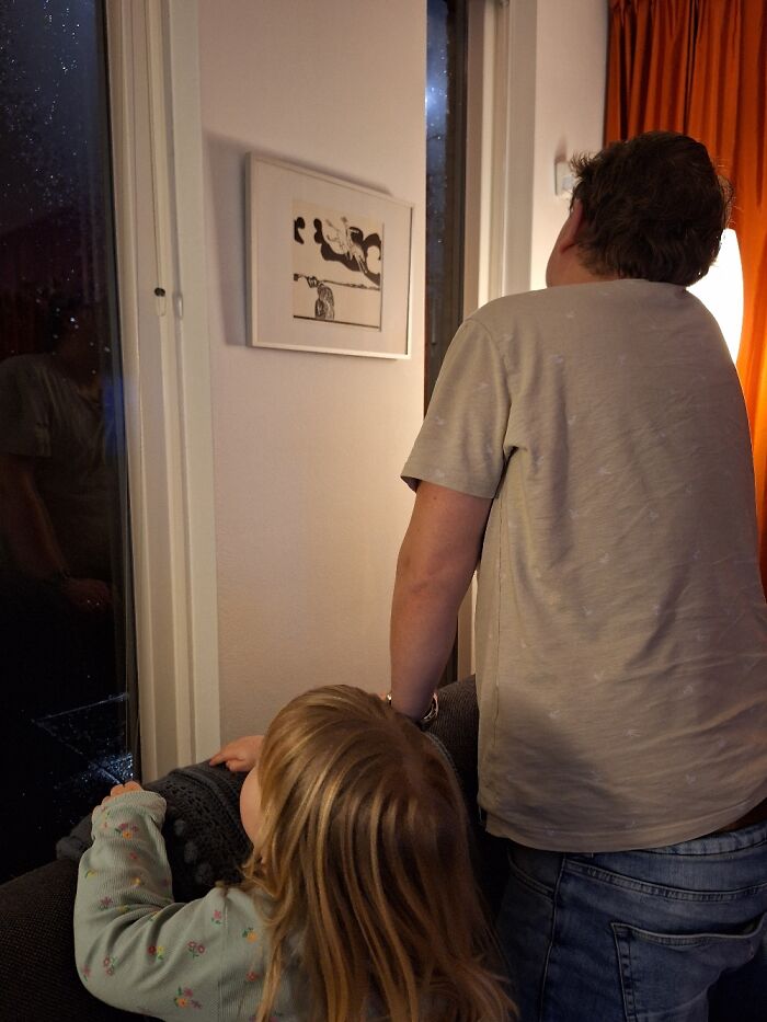 My Daughter And Husband Looking Out The Window At Fireworks