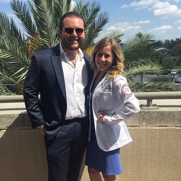 A couple smiling together outdoors, featuring child stars from School of Rock, 20 years after meeting.