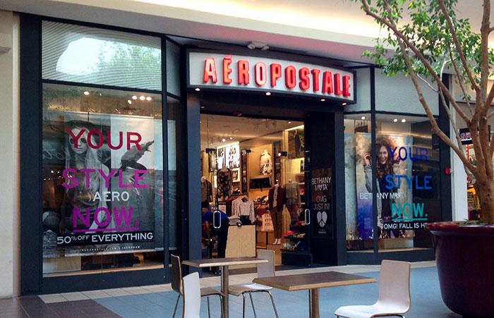 Aeropostale store entrance with sales signs displayed, showcasing retail workers’ stories environment.