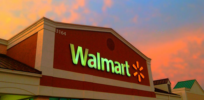 Walmart storefront under a vibrant sunset sky, highlighting retail stories.