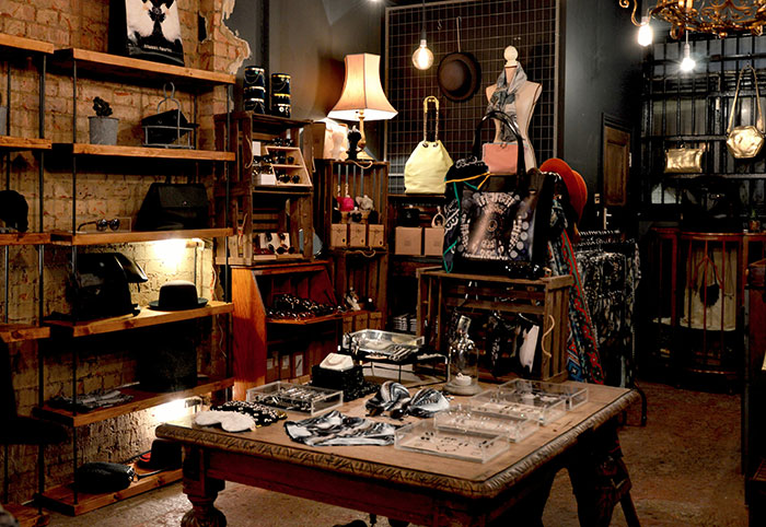 Vintage retail shop interior with eclectic displays, hats, and decor.