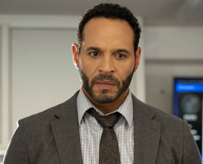 Daniel Sunjata in a gray suit and patterned tie looking serious; cast member of High Potential.