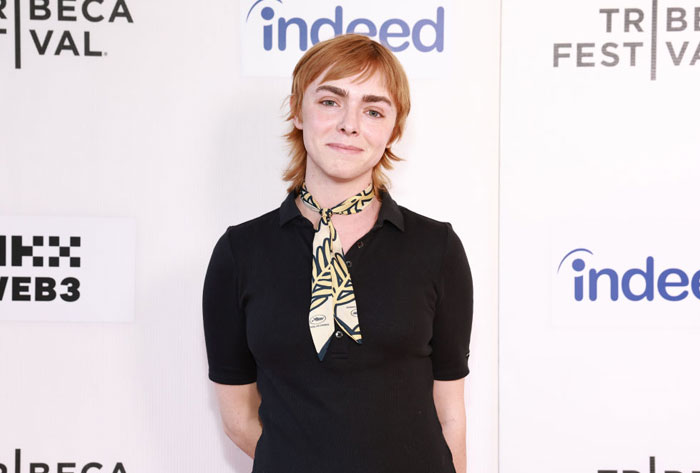 Elsie Fisher from "The Summer I Turned Pretty" at a festival event, wearing a black shirt and patterned scarf.