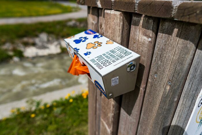 Outdoor tissue dispenser attached to a wooden post, highlighting clever tips for living cheap comfortably.