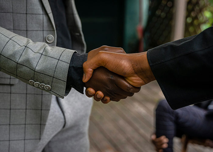 Two people shaking hands, showcasing a practical life cheat code.