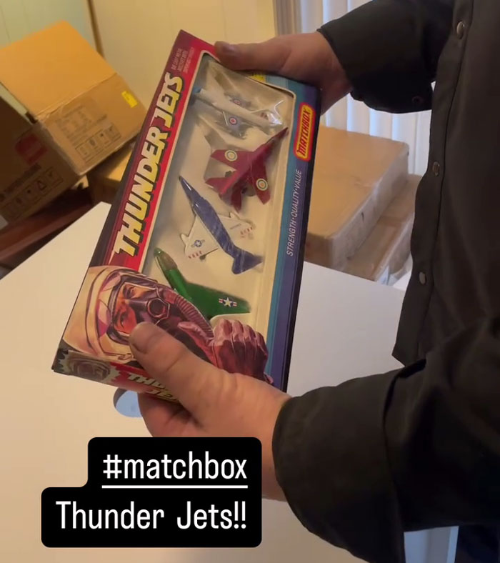 Man holding decades-old Matchbox Thunder Jets gift discovered during home reconstruction.