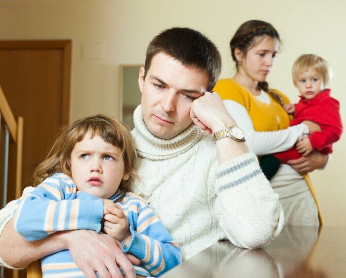 A thoughtful family at a table, pondering something they didn’t realize was messed up until older.