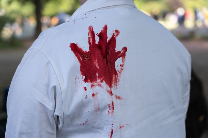 A white shirt with a red handprint stain, symbolizing career-ending resume red flags.