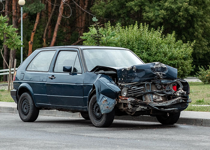 Damaged car on the roadside, symbolizing hidden family secrets and untold stories.