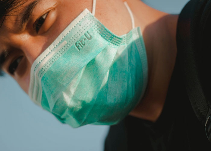 Person wearing a medical mask outdoors, highlighting unsettling medical facts.