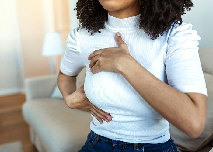 Person in white shirt touching their chest, illustrating unsettling medical facts.