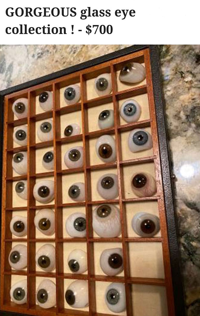 Glass eye collection displayed in a gridded box, available for sale online.