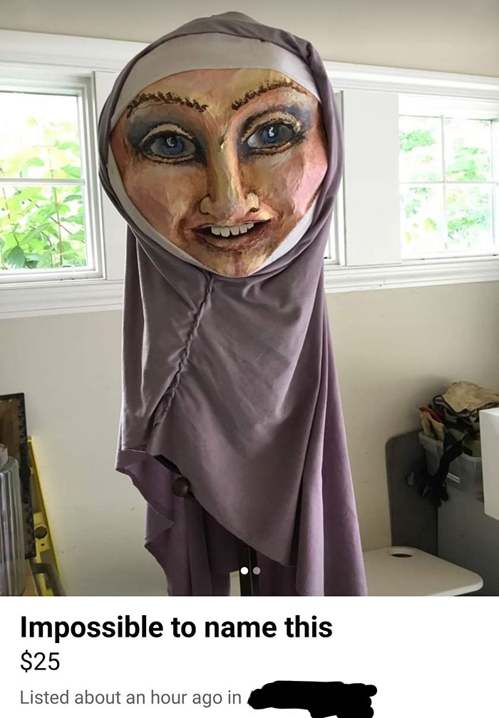 Creepy sculpture for sale with a human-like face and draped fabric, listed online.